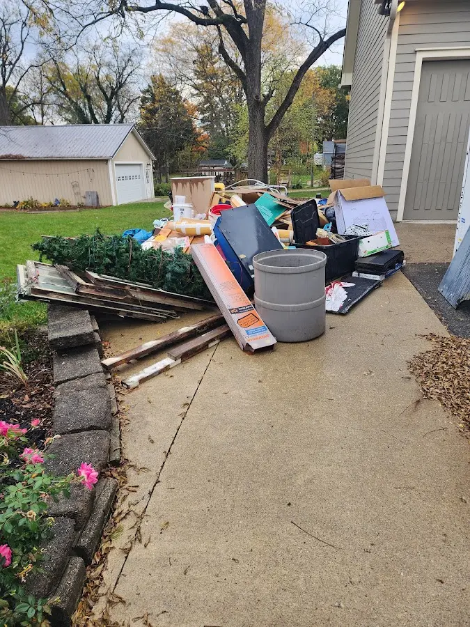 Dumpster being loaded with debris for Commercial Dumpster Rental in Hohenwald
